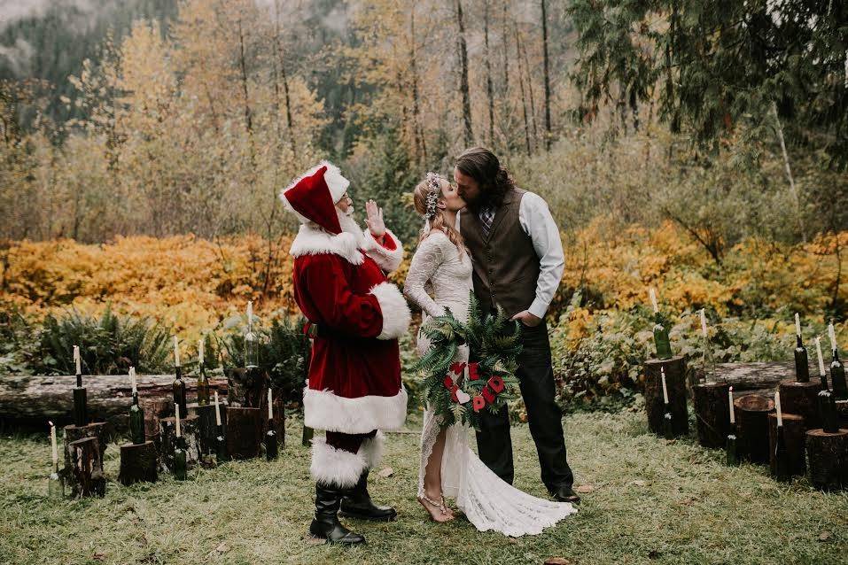 Couple kissing in front of Santa Clause