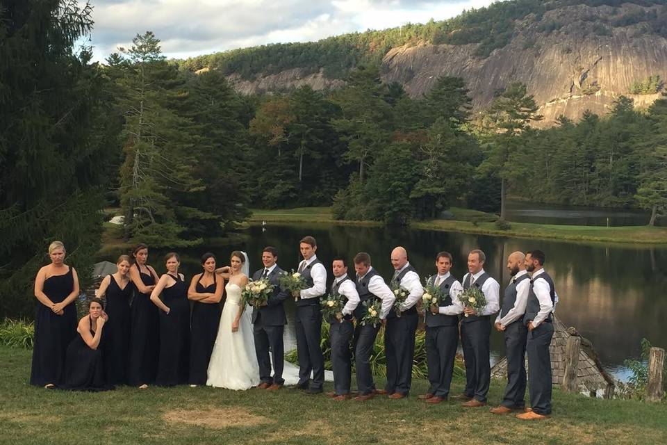 Newlyweds and their guests by the lake