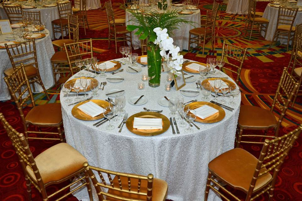 Beautiful table scape for your reception. Linens and chairs provided by kate ryan. Decor provided by tas event design. Linens/chairs: kate ryan linensdecor: tas eventsphotography: boone's professional events cake: corey's bakerydrapery: cheers! Events