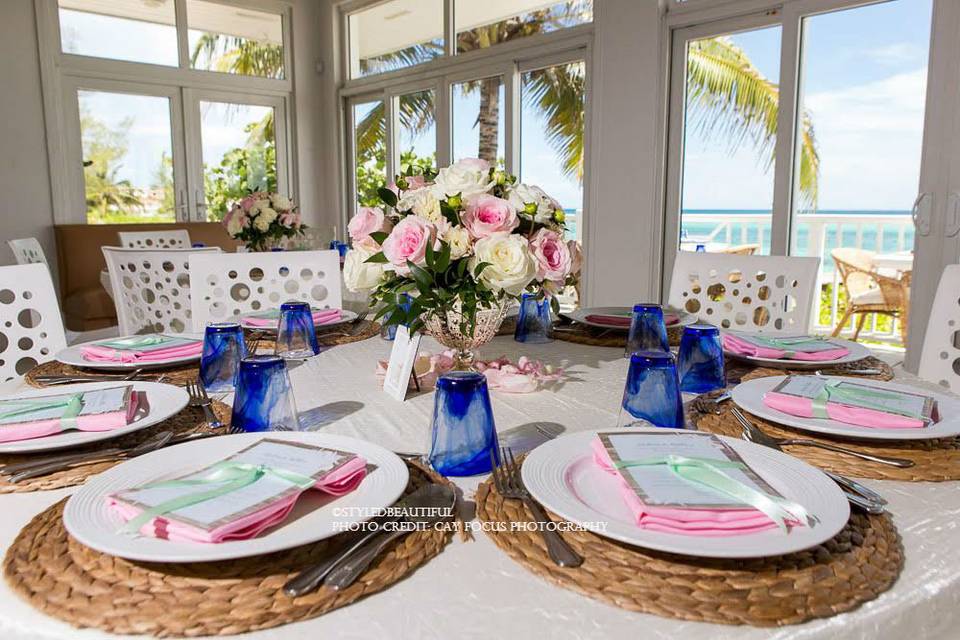 Beautiful setting for a Celebration of Life with a beach theme featuring  blue and yellow in the flowers and t…