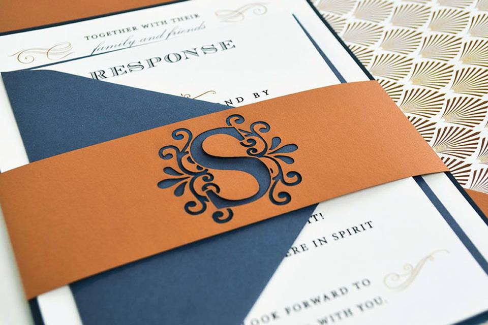 Laser cut monogram bellyband in Copper with envelopes in Cobalt and Imperial Blue.