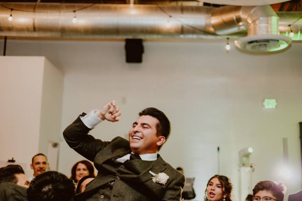 Groom being thrown in the air