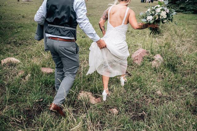 Groom holding brides dress