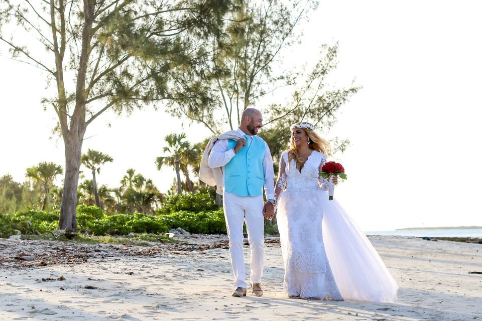 Newlyweds posing on a beach