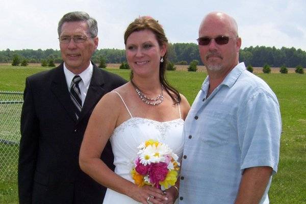 Newlyweds with officiant