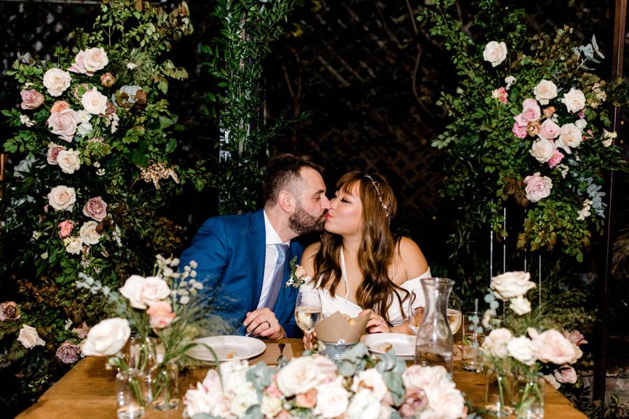 Newlyweds kiss amongst the flowers