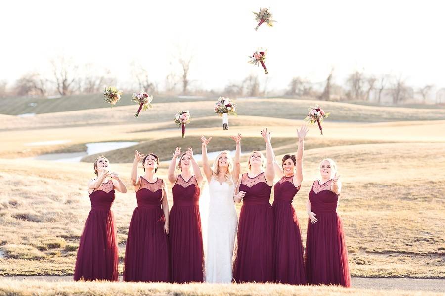 Bridal party throwing their bouquets