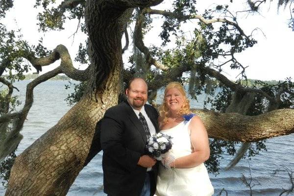 Newlyweds by the trees and water