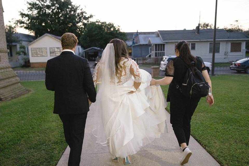 Wedding planner holds the gown!