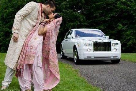 Bride and Groom along side their Phantom Rolls Royce