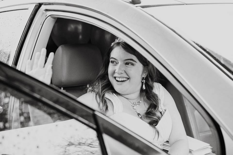 A bride driving a car