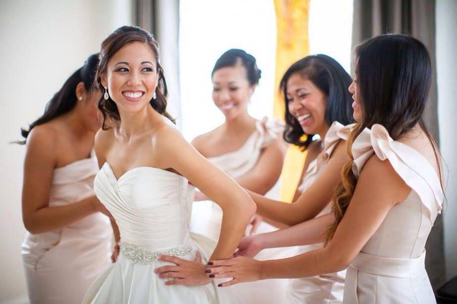 Bridesmaids helping the bride