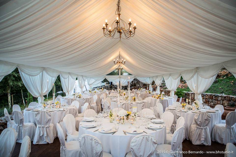 Round tables in tent ready for dinner