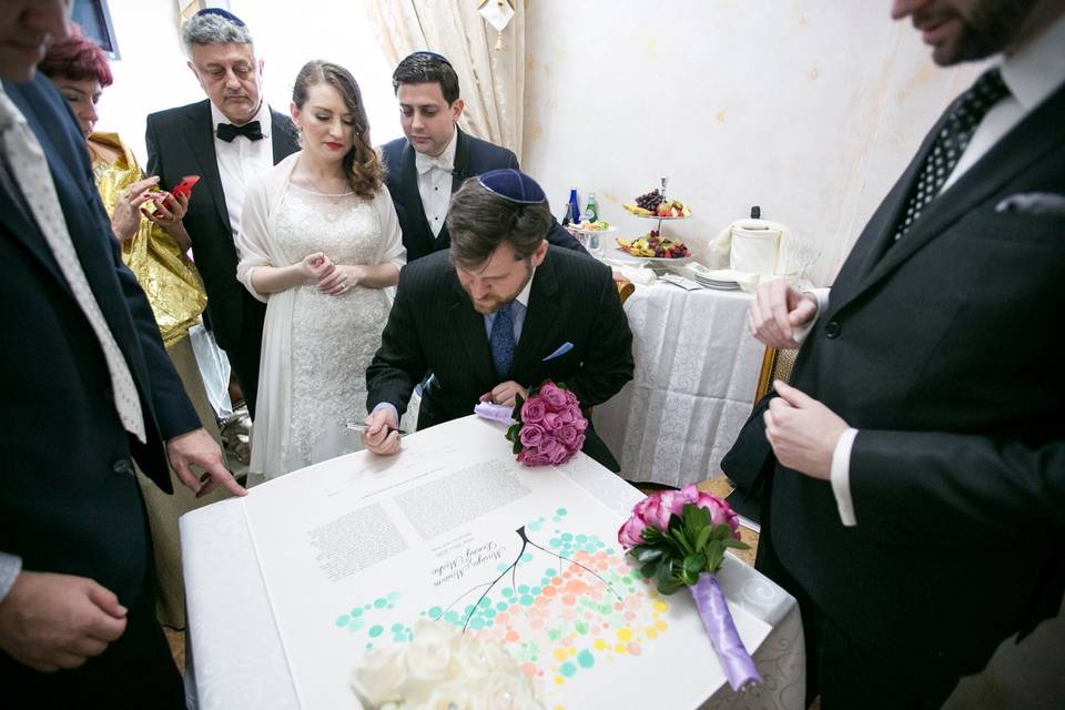 Rabbi supervises the signing o