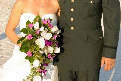 Newlyweds kissing behind the flower girl