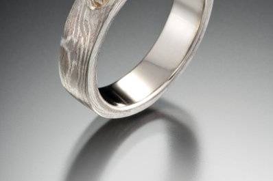 mokume gane engagement ring with blue sappihre
