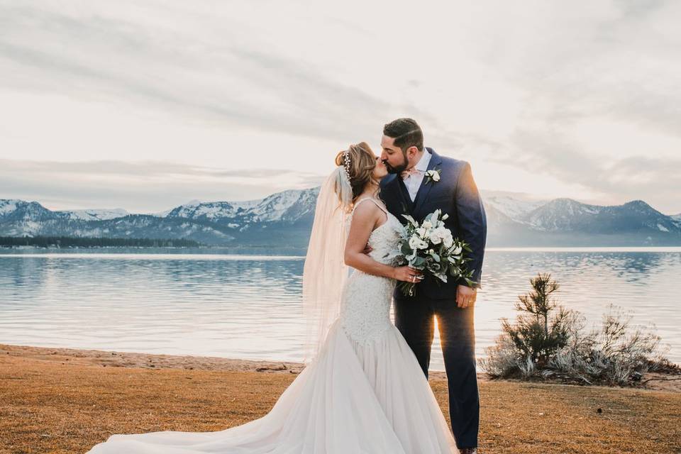 Newlyweds kissing outdoors