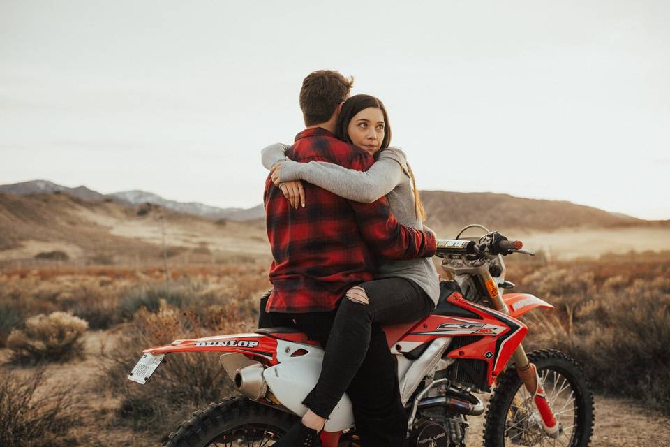 Couple embraces on a motor bike