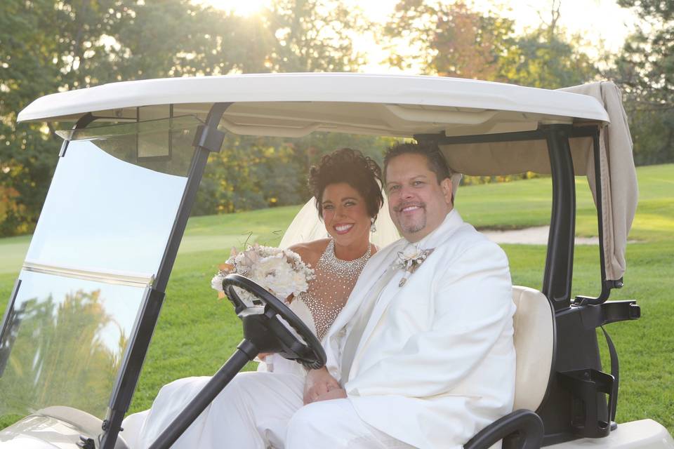 Newlyweds on their golf cart
