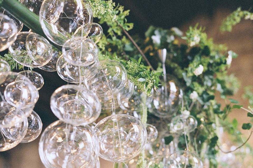 customized glass ball chandelier with cascading greenery