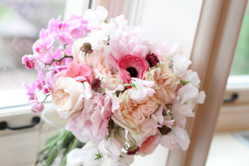 lush romantic bridal bouquet peonies, garden roses, Japanese Lysianthus, Phalaenopsis orchids, Dutch Garden Roses