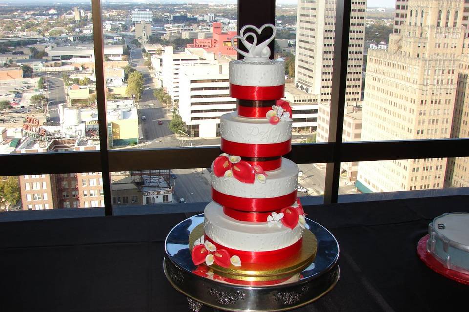 White cake with red ribbon bands