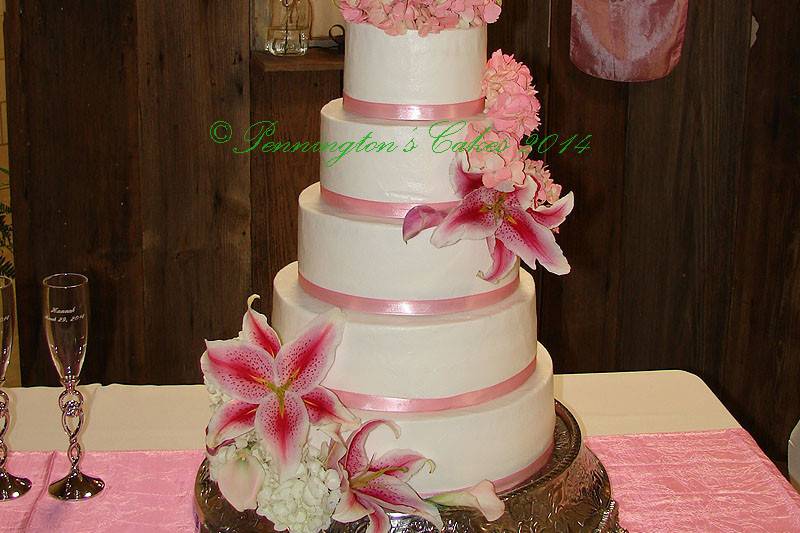 White cake with pink ribbon band