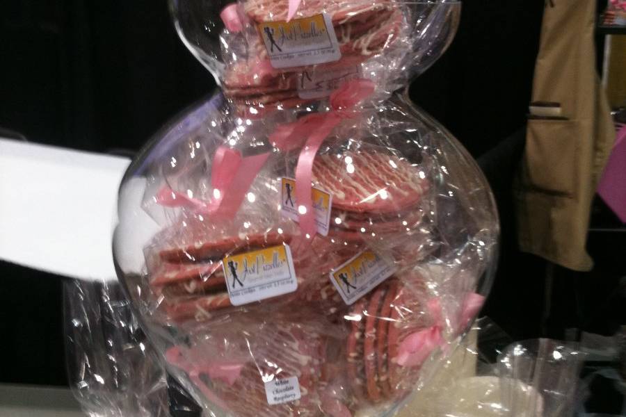 White Chocolate Raspberry pizzelle cookie packs in jar surrounded with Sugar Cookie pizzelle cookies