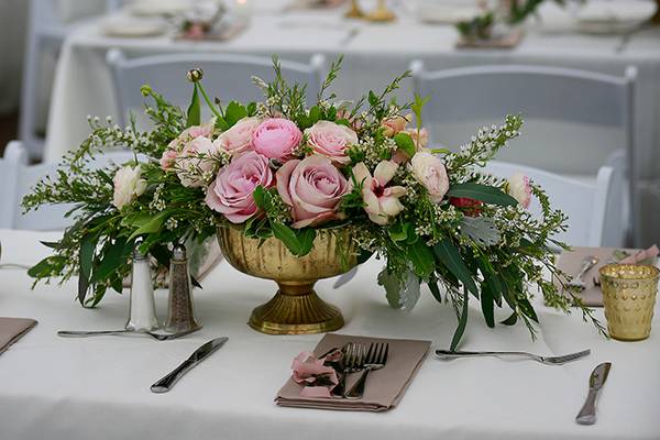 Floral centerpieces and candlelit dinner setup