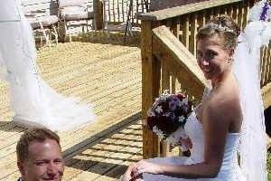 Groom kneeling for the bride