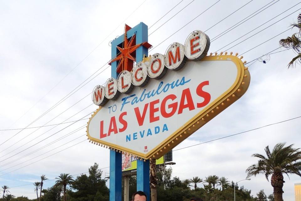 Newlyweds by the Las Vegas signage