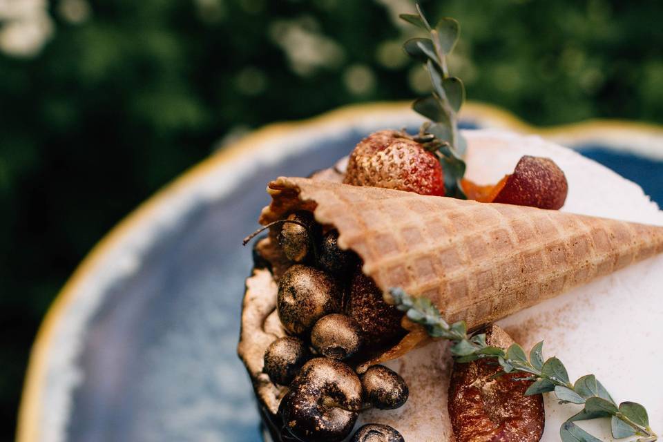 Cake topped with gold-dipped fruit