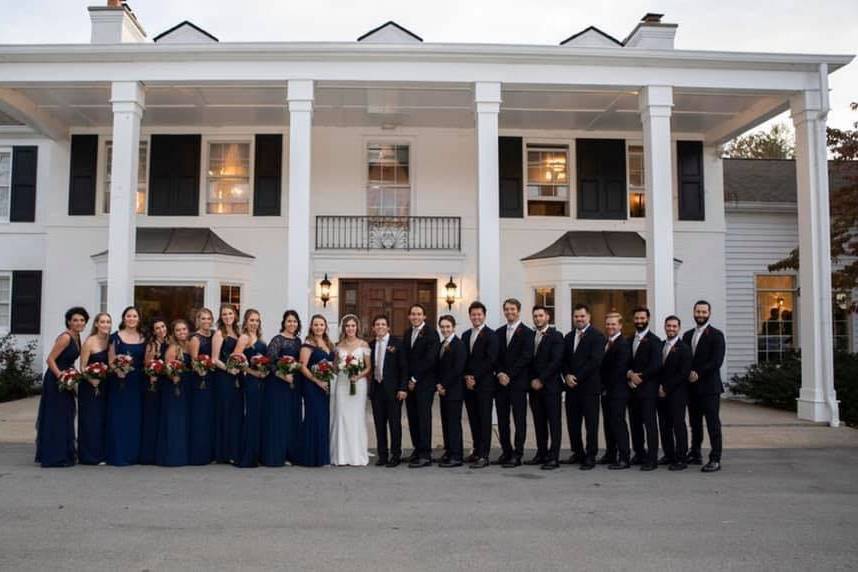 Wedding party in front of an estate