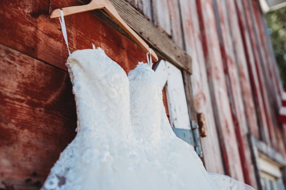 Wedding dress against barn