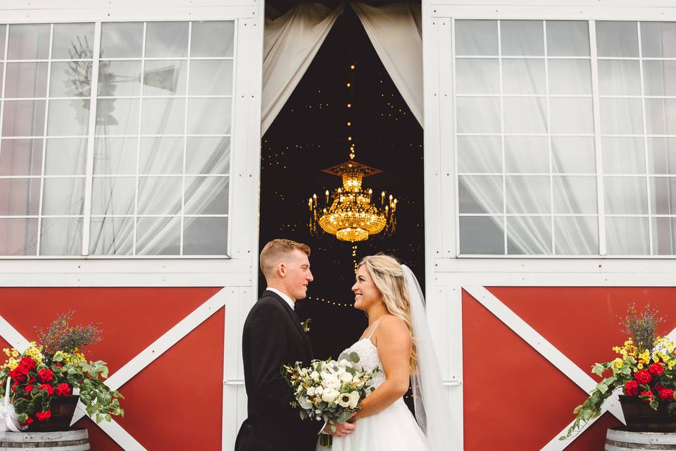 Bride and groom outside barn