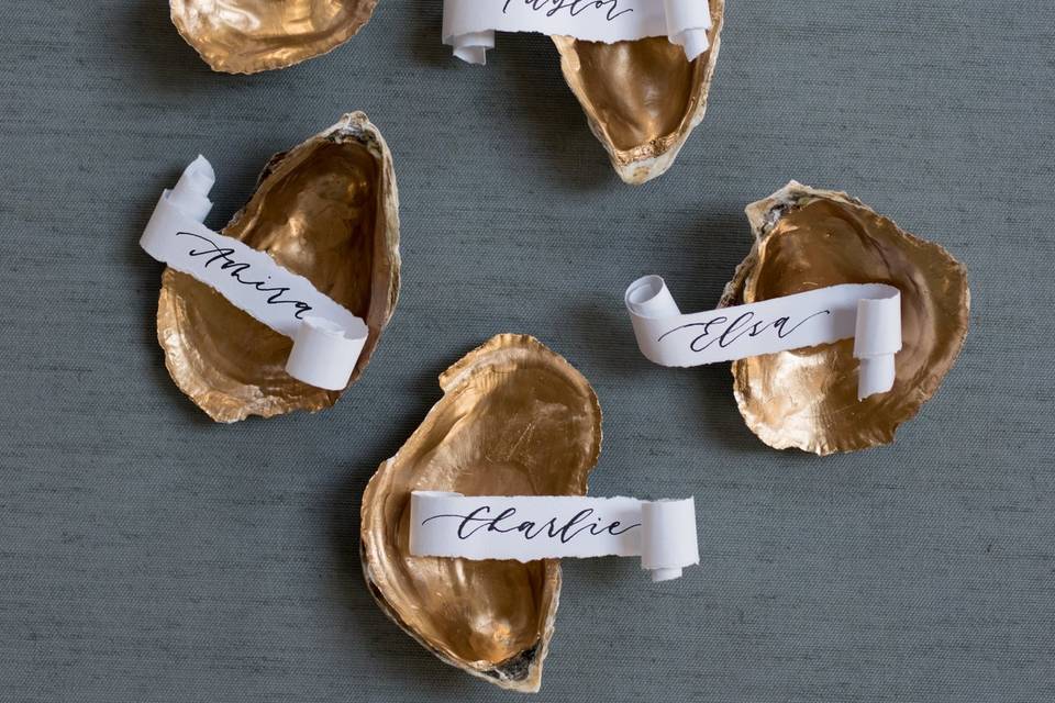 Calligraphy escort cards inside shells
