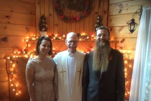 Smiling officiant with the newlyweds