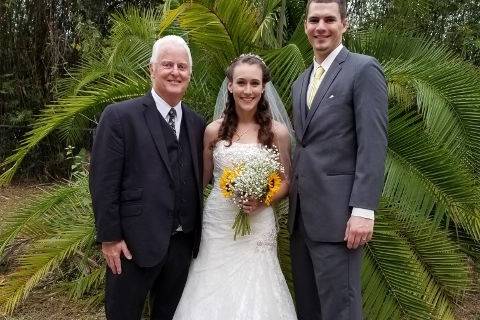 Wedding officiant with the bride and groom