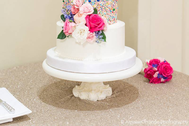 Buttercream wedding cake with custom sprinkles and fresh florals