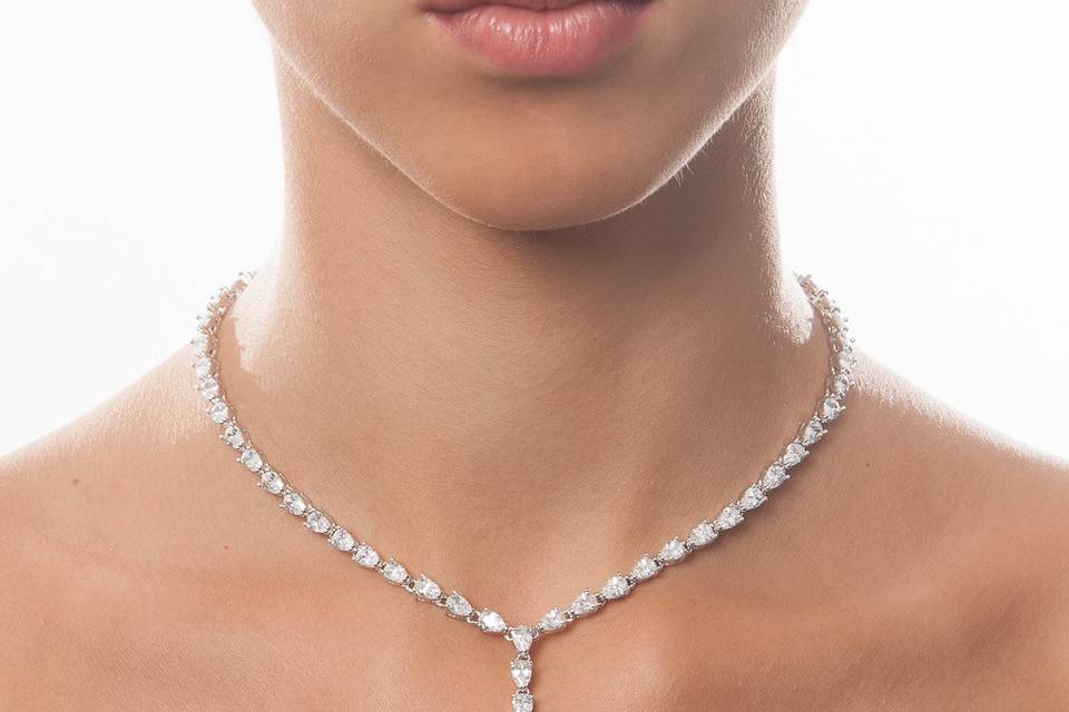 A true ladylike classic, this handcrafted tear drop necklace features clear cubic zirconia on a rhodium plated , silver metal base. Each stone radiates stunning reflections and evokes a truly opulent look. Pair this stunning piece with a delicate pair of dangle earrings to complete your look.
http://www.delilahk.com/delilahkbridal/wedding-necklaces-35/ida-tear-drop-necklace.html