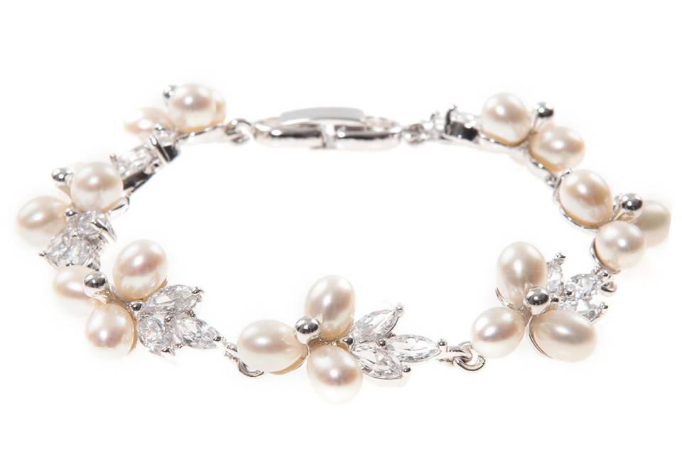 ROSA PEARL & CRYSTAL BRACELET
The delicacy of the Rosa bracelet speaks elegance and earthiness. Intricately hand set and polished, every freshwater pearl on this decadent piece contrasts the cubic zirconia stones marvelously, creating an everlasting shimmering appeal. Pair this piece with a delicate pearl necklace for ethereal elegance.
http://www.delilahk.com/delilahkbridal/rosa-pearl-crystal-bracelet.html