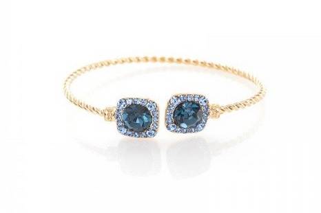 DELILAHK CRISTINA BLUE CRYSTAL TWISTED CUFF
Designed to layer on a bare wrist, the Cristina cuff sparkles with Montana blue colored crystals set on a gold plated base. Embellished in a clustered manner, this bracelet is an evening must-have.
http://www.delilahk.com/delilahkbridal/bridal-party/something-blue/delilahk-cristina-blue-crystal-twisted-cuff.html