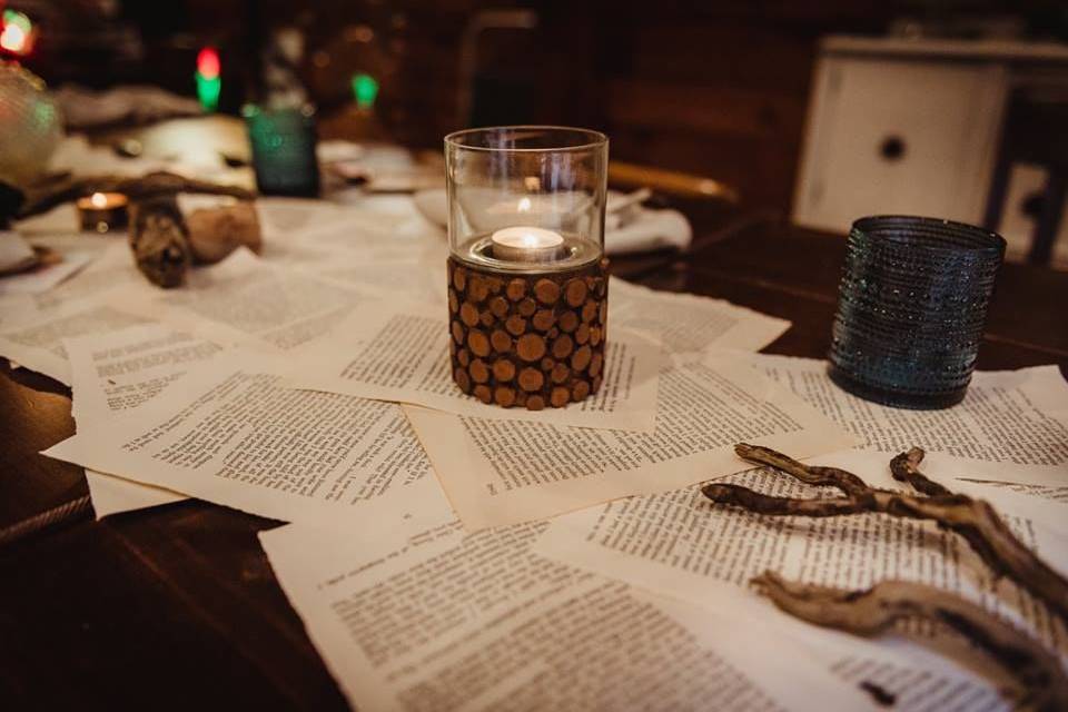 Books, wood, and paper by candlelight.