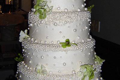 Intricately pearled wedding cake with vinework.