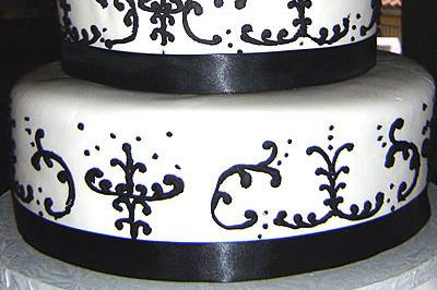 Elegant swirls black and white cake with huge rose topping!