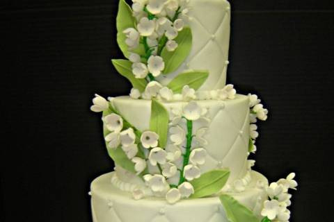 Stunning and bright 4 tier cake with leaves and flower work.