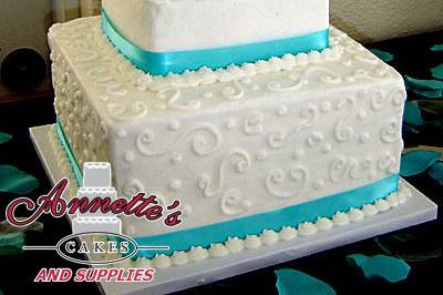 Splendid buttercream 3 tier with bright blue ribbonwork.