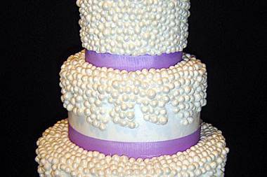 Opulent 4 tier cake with dazzling dotwork and beautiful lavender ribbon work!
