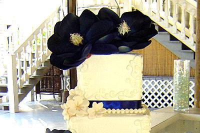 Perfect 4 tier quadratic cake with royal blue ribbon work and stunning handmade flowers!