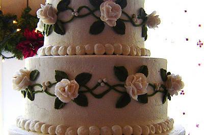 Impressive and clean 4 tier wedding cake with handcrafted flower accents and pearls.